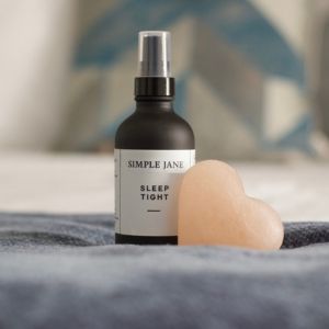 Bottle of Magnesium Oil on a bed used in the Dreamscapes spa experience.